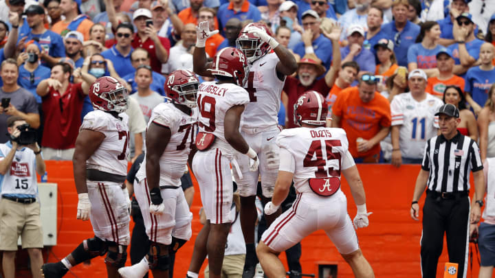 Sep 18, 2021; Gainesville, Florida, USA; Alabama Crimson Tide running back Brian Robinson Jr. (4) is congratulated as he scores a touchdown against the Florida Gators during the second half at Ben Hill Griffin Stadium. Mandatory Credit: Kim Klement-USA TODAY Sports