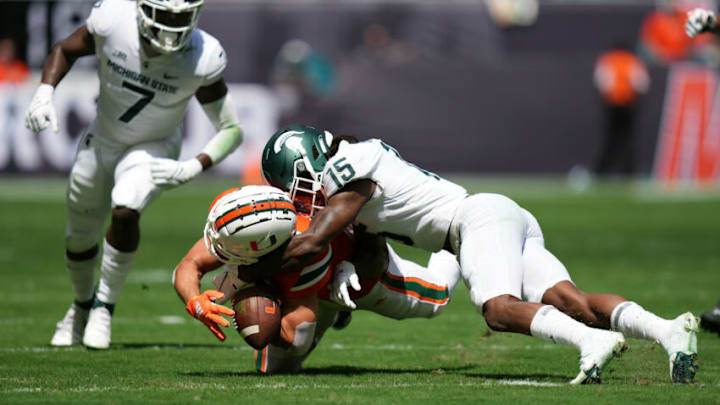 Sep 18, 2021; Miami Gardens, Florida, USA; Miami Hurricanes wide receiver Xavier Restrepo (7) and Michigan State Spartans safety Angelo Grose (15) attempt to recover the fumble of quarterback D'Eriq King (not pictured) during the first half at Hard Rock Stadium. Mandatory Credit: Jasen Vinlove-USA TODAY Sports