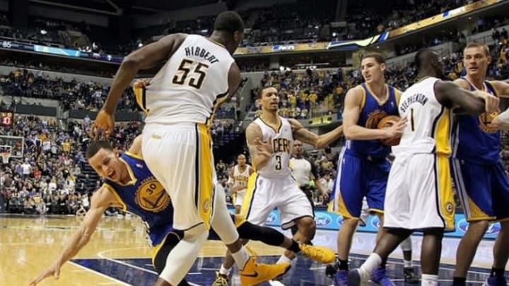 Feb 26 2013; Indianapolis, IN, USA; Indiana Pacers center Roy Hibbert (55) knocks down Golden State Warriors guard Stephen Curry (30) during the game at Bankers Life Fieldhouse. Mandatory Credit: Brian Spurlock-USA TODAY Sports