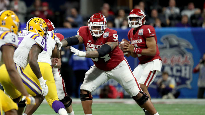 Atlanta, Georgia, USA; Oklahoma Sooners offensive lineman Marquis Hayes (54) blocks for quarterback Jalen Hurts (1) during the fourth quarter of the 2019 Peach Bowl college football playoff semifinal game between the LSU Tigers and the Oklahoma Sooners at Mercedes-Benz Stadium. Mandatory Credit: Jason Getz-USA TODAY Sports