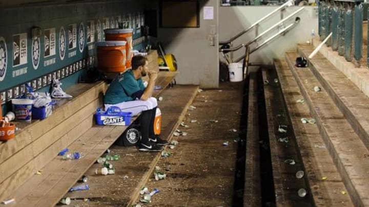 Jun 12, 2013; Seattle, WA, USA; Seattle Mariners closing pitcher Tom Wilhelmsen (54) sits alone in the dugout after giving up 5 runs in the 9th inning and earning the loss against the Houston Astros at Safeco Field. Houston defeated Seattle 6-1. Mandatory Credit: Steven Bisig-USA TODAY Sports