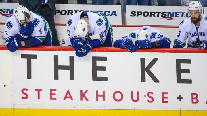 Apr 25, 2015; Calgary, Alberta, CAN; Vancouver Canucks players reacts to the goal by Calgary Flames left wing Jiri Hudler (not pictured) during the third period in game six of the first round of the 2015 Stanley Cup Playoffs at Scotiabank Saddledome. Calgary Flames won 7-4. Mandatory Credit: Sergei Belski-USA TODAY Sports