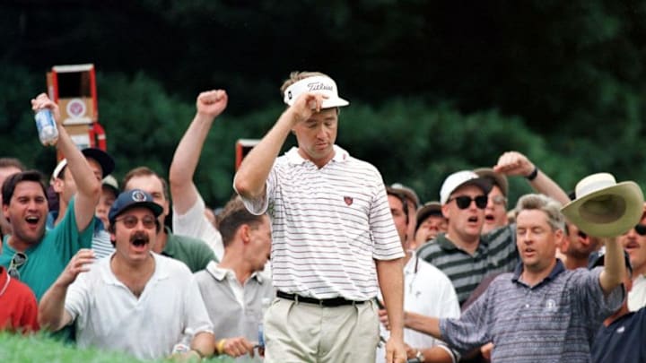 MAMARONECK, UNITED STATES: Davis Love III of the US tips his hat as the crowd goes wild after his chip shot to the 12th green 17 August during the final round of the PGA Championship at Winged Foot. Love won the championship, finishing 11-under-par. AFP PHOTO/Jon LEVY (Photo credit should read JON LEVY/AFP via Getty Images)