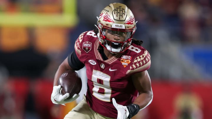 Dec 29, 2022; Orlando, Florida, USA; Florida State Seminoles running back Treshaun Ward (8) runs with the ball against the Oklahoma Sooners in the fourth quarter during the 2022 Cheez-It Bowl at Camping World Stadium. Mandatory Credit: Nathan Ray Seebeck-USA TODAY Sports