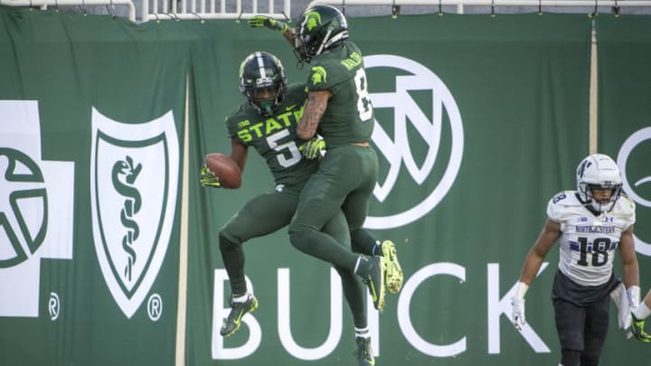 EAST LANSING, MI - NOVEMBER 28: Jayden Reed #5 of the Michigan State Spartans and Jalen Nailor #8 of the Michigan State Spartans celebrate a touchdown against the Northwestern Wildcats during the second quarter at Spartan Stadium on November 28, 2020 in East Lansing, Michigan. (Photo by Nic Antaya/Getty Images)