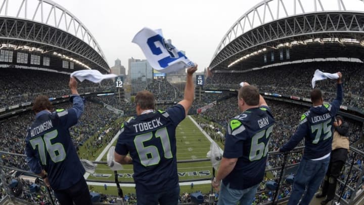 Nov 2, 2014; Seattle, WA, USA; Seattle Seahawks former players Steve Hutchinson (76), Robert Tobeck (61), Chris Gray (62) and Sean Locklear (75) wave 12th man rally towels before the game against the Oakland Raiders at CenturyLink Field. Mandatory Credit: Kirby Lee-USA TODAY Sports