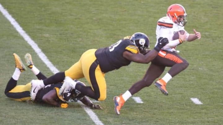 Nov 15, 2015; Pittsburgh, PA, USA; Cleveland Browns quarterback Johnny Manziel (2) scrambles with the ball as Pittsburgh Steelers defensive end Cam Thomas (93) and inside linebacker Lawrence Timmons (94) defend during the third quarter at Heinz Field. The Steelers won 30-9. Mandatory Credit: Charles LeClaire-USA TODAY Sports