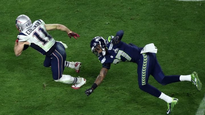 Feb 1, 2015; Glendale, AZ, USA; New England Patriots wide receiver Julian Edelman (11) runs the ball against Seattle Seahawks cornerback Tharold Simon (27) during the fourth quarter in Super Bowl XLIX at University of Phoenix Stadium. Mandatory Credit: Richard Mackson-USA TODAY Sports