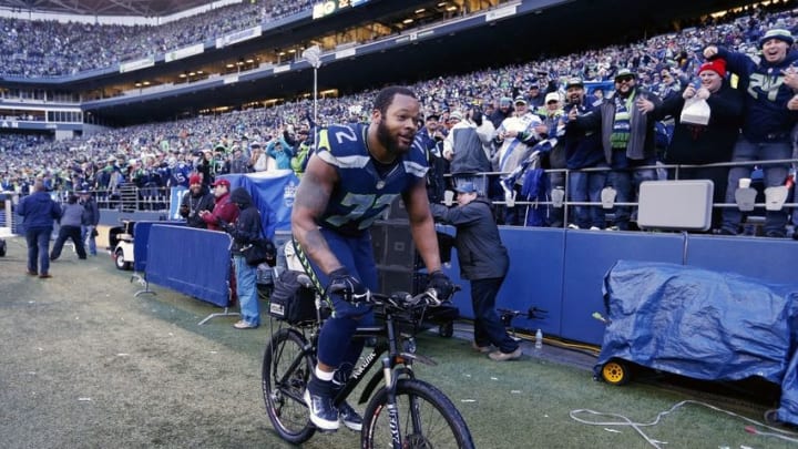 January 18, 2015; Seattle, WA, USA; Seattle Seahawks defensive end Michael Bennett (72) rides a bicycle following the 28-22 victory against the Green Bay Packers in the NFC Championship game at CenturyLink Field. Mandatory Credit: Joe Nicholson-USA TODAY Sports