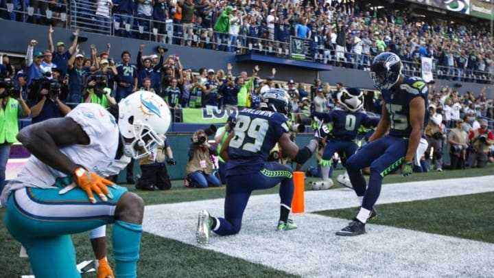 Sep 11, 2016; Seattle, WA, USA; Seattle Seahawks wide receiver Doug Baldwin (89) celebrates his touchdown reception against the Miami Dolphins with wide receiver Jermaine Kearse (15) during the fourth quarter at CenturyLink Field. Miami Dolphins cornerback Bobby McCain (28) is at left. Seattle defeated Miami, 12-10. Mandatory Credit: Joe Nicholson-USA TODAY Sports