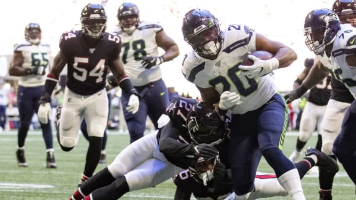 ATLANTA, GA - OCTOBER 27: Rashaad Penny #20 of the Seattle Seahawks runs with the ball under pressure from defender Damontae Kazee #27 of the Atlanta Falcons during the second quarter of a game at Mercedes-Benz Stadium on October 27, 2019 in Atlanta, Georgia. (Photo by Carmen Mandato/Getty Images)