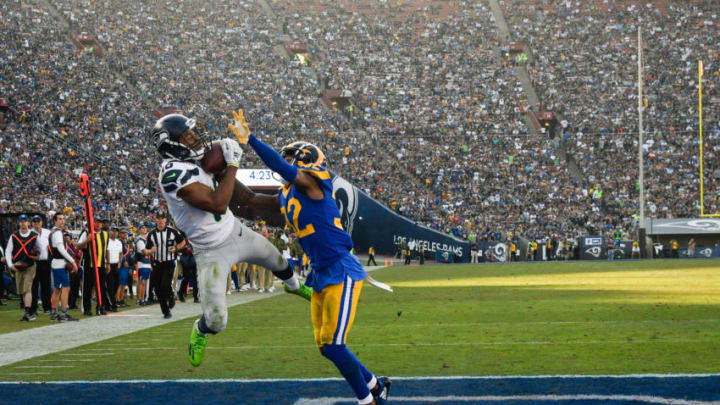 LOS ANGELES, CA - NOVEMBER 11: Wide receiver Tyler Lockett #16 of the Seattle Seahawks makes a catch to score a touchdown in front of cornerback Troy Hill #32 of the Los Angeles Rams in the third quarter at Los Angeles Memorial Coliseum on November 11, 2018 in Los Angeles, California. (Photo by John McCoy/Getty Images)