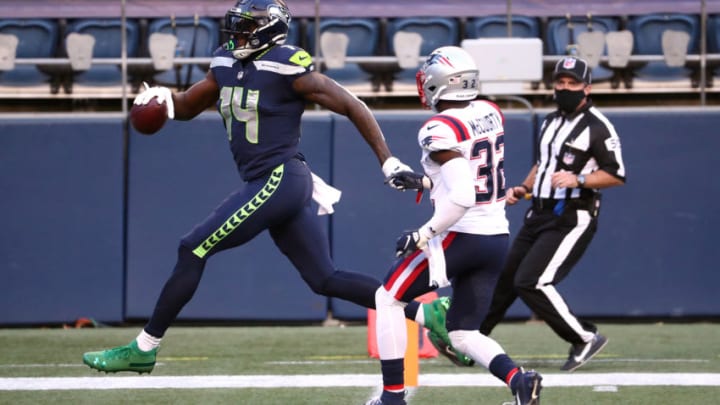 SEATTLE, WASHINGTON - SEPTEMBER 20: DK Metcalf #14 of the Seattle Seahawks scores a second quarter touchdown against Devin McCourty #32 of the New England Patriots at CenturyLink Field on September 20, 2020 in Seattle, Washington. (Photo by Abbie Parr/Getty Images)