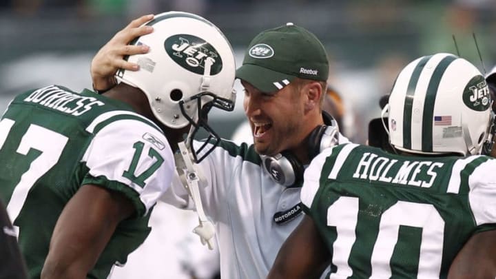 EAST RUTHERFORD, NJ - NOVEMBER 27: New York Jets offensive coordinator Brian Schottenheimer celebrates with Plaxico Burress #17 and Santonio Holmes #10 of the New York Jets during their game against the Buffalo Bills at MetLife Stadium on November 27, 2011 in East Rutherford, New Jersey. (Photo by Jeff Zelevansky/Getty Images)