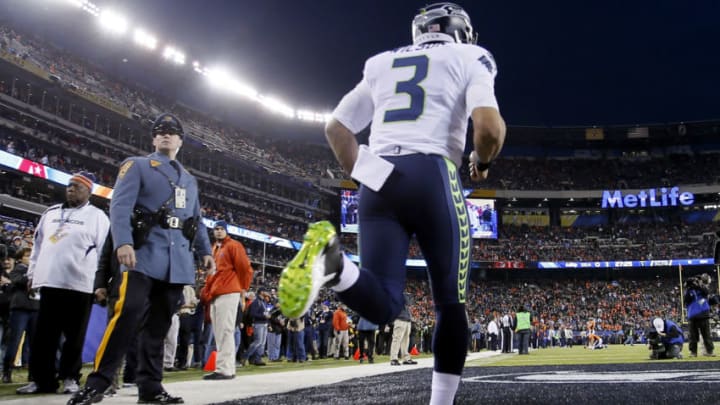 EAST RUTHERFORD, NJ - FEBRUARY 02: Quarterback Russell Wilson #3 of the Seattle Seahawks runs onto the field before playing against the Denver Broncos during Super Bowl XLVIII at MetLife Stadium on February 2, 2014 in East Rutherford, New Jersey. (Photo by Kevin C. Cox/Getty Images)