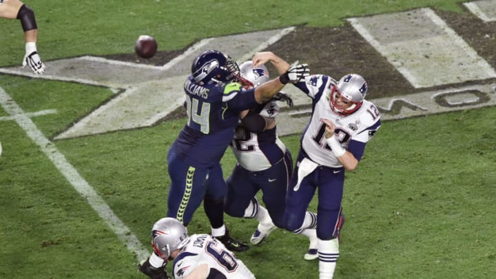 GLENDALE, AZ - FEBRUARY 01 : Tom Brady #12 of the New England Patriots gets his pass off under pressure from Kevin Williams #94 of the Seattle Seahawks in Super Bowl XLIX February 1, 2015 at the University of Phoenix Stadium in Glendale, Arizona. The Patriots won the game 28-24. (Photo by Focus on Sport/Getty Images)