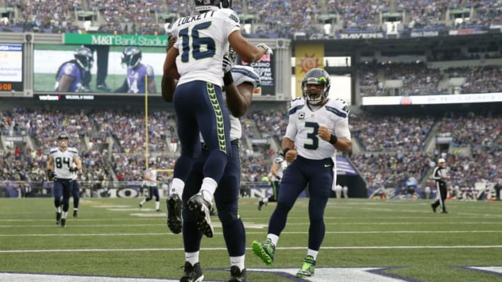 BALTIMORE, MD - DECEMBER 13: Wide receiver Tyler Lockett #16 of the Seattle Seahawks celebrates with teammates defensive end Frank Clark #55 and quarterback Russell Wilson #3 after scoring a first quarter touchdown against the Baltimore Ravens at M&T Bank Stadium on December 13, 2015 in Baltimore, Maryland. (Photo by Rob Carr/Getty Images)