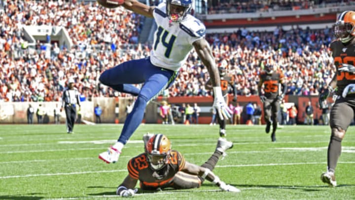 CLEVELAND, OHIO – OCTOBER 13: D.K. Metcalf #14 of the Seattle Seahawks leaps over Damarious Randall #23 of the Cleveland Browns or extra yards during the second quarter at FirstEnergy Stadium on October 13, 2019 in Cleveland, Ohio. (Photo by Jason Miller/Getty Images)