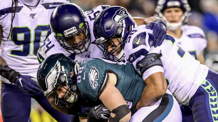 PHILADELPHIA, PENNSYLVANIA - JANUARY 05: Dallas Goedert #88 of the Philadelphia Eagles is tackled by Bobby Wagner #54 and Bradley McDougald #30 of the Seattle Seahawks in the NFC Wild Card Playoff game at Lincoln Financial Field on January 05, 2020 in Philadelphia, Pennsylvania. (Photo by Steven Ryan/Getty Images)