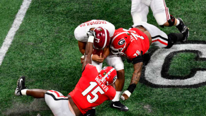 ATLANTA, GA – JANUARY 08: Tua Tagovailoa #13 of the Alabama Crimson Tide is tackled by D’Andre Walker #15 and Trenton Thompson #78 of the Georgia Bulldogs in the CFP National Championship presented by AT&T at Mercedes-Benz Stadium on January 8, 2018 in Atlanta, Georgia. (Photo by Scott Cunningham/Getty Images)