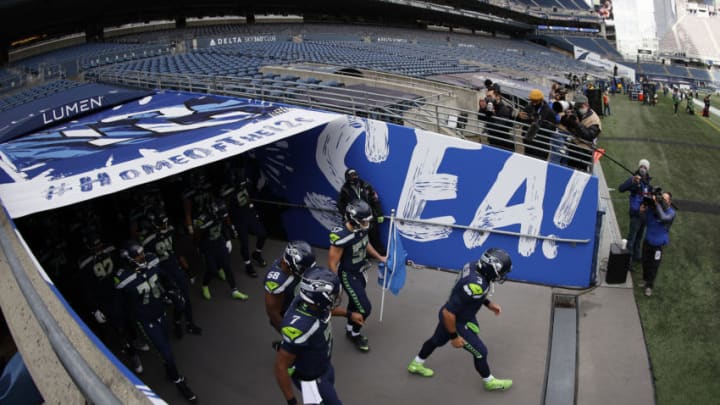 SEATTLE, WASHINGTON - JANUARY 09: Quarterback Russell Wilson #3 of the Seattle Seahawks leads his team onto the field to start the NFC Wild Card Playoff game against the Los Angeles Rams at Lumen Field on January 09, 2021 in Seattle, Washington. (Photo by Steph Chambers/Getty Images)