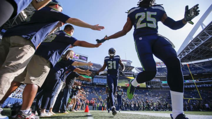 Aug 25, 2017; Seattle, WA, USA; Seattle Seahawks cornerback Richard Sherman (25) and strong safety Kam Chancellor (31) lead the secondary out onto the field for pregame warmups against the Kansas City Chiefs at CenturyLink Field. Mandatory Credit: Joe Nicholson-USA TODAY Sports