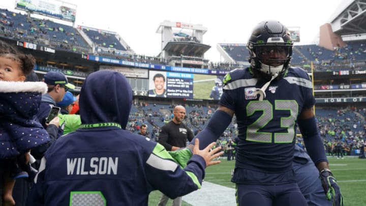 Oct 20, 2019; Seattle, WA, USA; Seattle Seahawks defensive back Neiko Thorpe (23) greats a fan wearing a No.3 Russell Wilson jersey before the game against the Baltimore Ravens at CenturyLink Field. Mandatory Credit: Kirby Lee-USA TODAY Sports