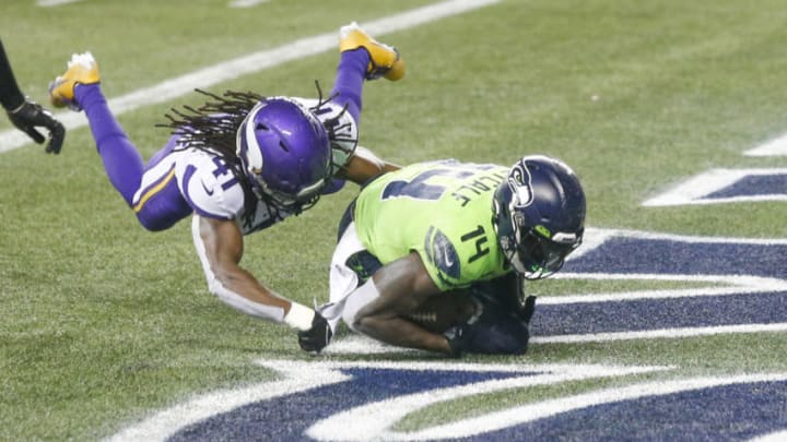 Oct 11, 2020; Seattle, Washington, USA; Seattle Seahawks wide receiver DK Metcalf (14) catches a touchdown pass against Minnesota Vikings free safety Anthony Harris (41) during the fourth quarter at CenturyLink Field. Mandatory Credit: Joe Nicholson-USA TODAY Sports