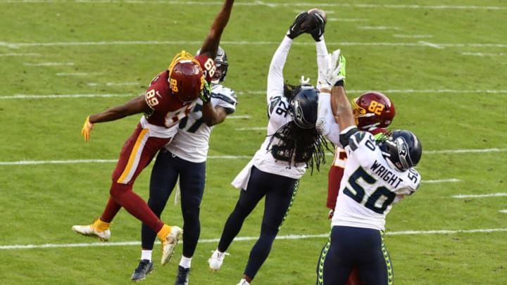 Dec 20, 2020; Landover, Maryland, USA; Seattle Seahawks cornerback Shaquill Griffin (26) breaks up a pass intended for Washington Football Team wide receiver Cam Sims (89) during the second half at FedExField. Mandatory Credit: Brad Mills-USA TODAY Sports