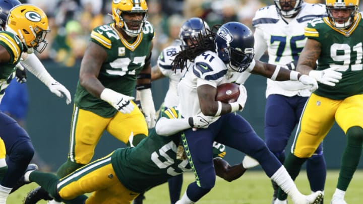 Nov 14, 2021; Green Bay, Wisconsin, USA; Seattle Seahawks running back Alex Collins (41) is tackled by Green Bay Packers outside linebacker De'Vondre Campbell (59) during the first quarter at Lambeau Field. Mandatory Credit: Jeff Hanisch-USA TODAY Sports