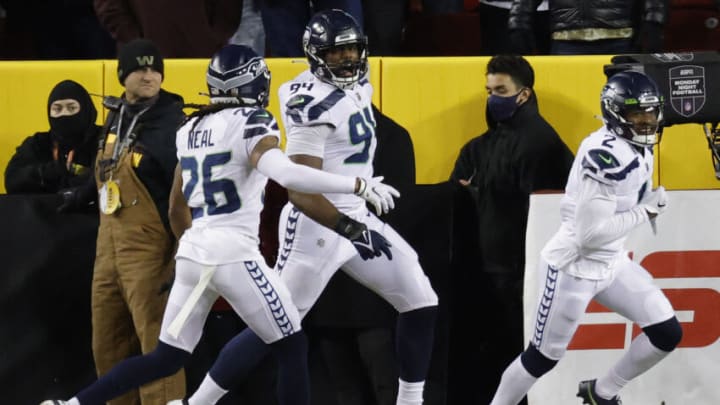 Nov 29, 2021; Landover, Maryland, USA; Seattle Seahawks defensive end Rasheem Green (94) celebrates with Seahawks safety Ryan Neal (26) after returning a blocked extra point for two points against the Washington Football Team during the second quarter at FedExField. Mandatory Credit: Geoff Burke-USA TODAY Sports