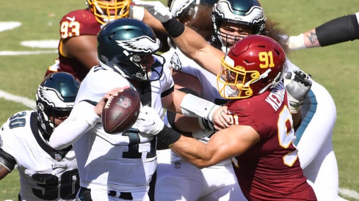 Sep 13, 2020; Landover, Maryland, USA; Washington Football Team defensive end Ryan Kerrigan (91) sacks Philadelphia Eagles quarterback Carson Wentz (11) during the second half quarter at FedExField. Mandatory Credit: Brad Mills-USA TODAY Sports