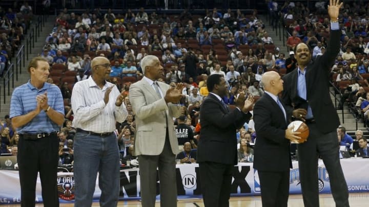 Oct 9, 2013; Jacksonville, FL, USA; NBA legend Artis Gilmore (right) is recognized during a break in the second half of the Orlando Magic game against the New Orleans Pelicans at Jacksonville Veterans Memorial Arena. Other NBA legends include, from left, Rick Barry, and George Gervin and Julius Erving. The New Orleans Pelicans beat the Orlando Magic 99-95. Mandatory Credit: Phil Sears-USA TODAY Sports