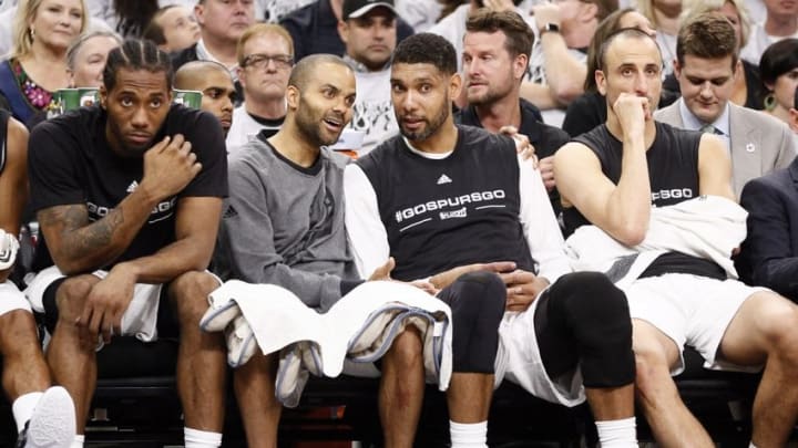 Apr 30, 2016; San Antonio, TX, USA; San Antonio Spurs players (from left to right) Kawhi Leonard, and Tony Parker, and Tim Duncan, and Manu Ginobili (20) watch on the bench against the Oklahoma City Thunder in game one of the second round of the NBA Playoffs at AT&T Center. Mandatory Credit: Soobum Im-USA TODAY Sports