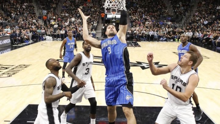 Nov 29, 2016; San Antonio, TX, USA; Orlando Magic center Nikola Vucevic (9) shoots the ball as San Antonio Spurs shooting guard Jonathon Simmons (17, left), and center Dewayne Dedmon (3), and power forward David Lee (10) look on during the second half at AT&T Center. Mandatory Credit: Soobum Im-USA TODAY Sports Nov 29, 2016; San Antonio, TX, USA; Orlando Magic center Nikola Vucevic (9) shoots the ball as San Antonio Spurs shooting guard Jonathon Simmons (17, left), and center Dewayne Dedmon (3), and power forward David Lee (10) look on during the second half at AT&T Center. Mandatory Credit: Soobum Im-USA TODAY Sports
