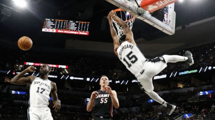 SAN ANTONIO,TX - SEPTEMBER 30 : Jaron Blossomgame #15 of the San Antonio Spurs dunks in front of Duncan Robinson #55 of the Miami Heat in a Preseason game at AT&T Center on September 30 , 2018 in San Antonio, Texas. NOTE TO USER: User expressly acknowledges and agrees that , by downloading and or using this photograph, User is consenting to the terms and conditions of the Getty Images License Agreement. (Photo by Ronald Cortes/Getty Images)