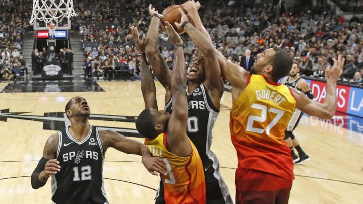 SAN ANTONIO,TX – DECEMBER 09: DeMar DeRozan #10 of the San Antonio Spurs has his shot blocked by Rudy Gobert #27 of the Utah Jazz and Royce ONeil #23 (Photo by Ronald Cortes/Getty Images)