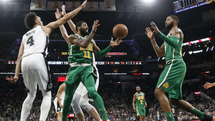 SAN ANTONIO, TX – DECEMBER 31: Kyrie Irving #11 of the Boston Celtics passes off to Marcus Morris #13 as Derrick White #4 of the San Antonio Spurs defends (Photo by Ronald Cortes/Getty Images)