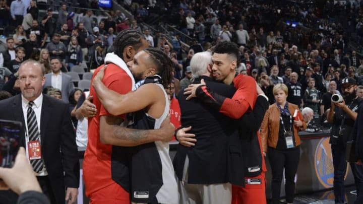 SAN ANTONIO, TX - JANUARY 3: Kawhi Leonard #2 of the Toronto Raptors Patty Mills #8 of the San Antonio Spurs Head Coach Gregg Popovich of the San Antonio Spurs and Danny Green #14 of the Toronto Raptors exchange hugs after the game on January 3, 2019 at the AT&T Center in San Antonio, Texas. NOTE TO USER: User expressly acknowledges and agrees that, by downloading and or using this photograph, user is consenting to the terms and conditions of the Getty Images License Agreement. Mandatory Copyright Notice: Copyright 2019 NBAE (Photos by Mark Sobhani/NBAE via Getty Images)