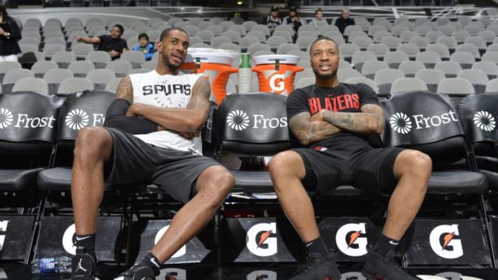 SAN ANTONIO, TX - MARCH 16: LaMarcus Aldridge #12 of the San Antonio Spurs and Damian Lillard #0 of the Portland Trail Blazers talks before a game (Photos by Mark Sobhani/NBAE via Getty Images)