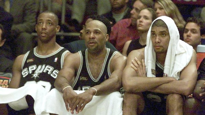 San Antonio Spurs players Sean Elliott (L), Mario Elie (C) and Tim Duncan watch from the bench as the Spurs lose to the New York Knicks during game three of the NBA Finals (ROBERT SULLIVAN/AFP via Getty Images)