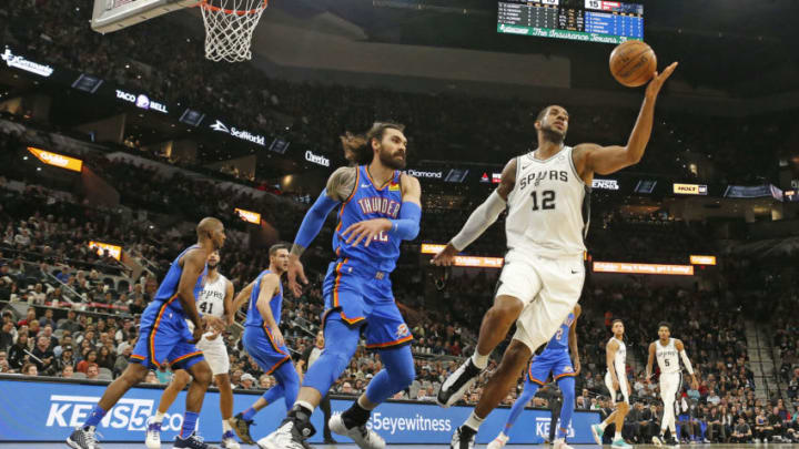 SAN ANTONIO, TX - JANUARY 2: LaMarcus Aldridge #12 of the San Antonio Spurs reaches for a loose ball agains Steven Adams #12 of the Oklahoma City Thunder during first half action at AT&T Center on January 2, 2020 in San Antonio, Texas. NOTE TO USER: User expressly acknowledges and agrees that , by downloading and or using this photograph, User is consenting to the terms and conditions of the Getty Images License Agreement. (Photo by Ronald Cortes/Getty Images)