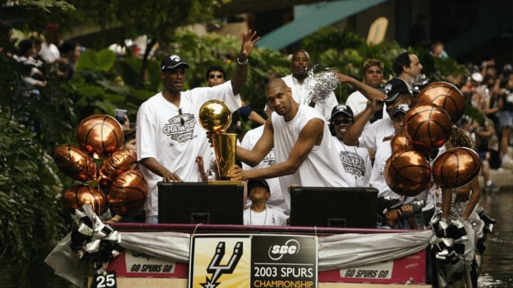 SAN ANTONIO – JUNE 18: (L-R) David Robinson #50 and Tim Duncan #21 of the San Antonio Spurs celebrate with their trophy during the SBC 2003 Spurs Championship Celebration. (Photo by Ronald Martinez/Getty Images)