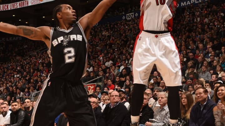 TORONTO, ON – FEBRUARY 8: DeMar DeRozan #10 of the Toronto Raptors shoots against Kawhi Leonard #2 of the San Antonio Spurs on February 8, 2015 at the Air Canada Centre in Toronto, Ontario, Canada. (Photo by Ron Turenne/NBAE via Getty Images)