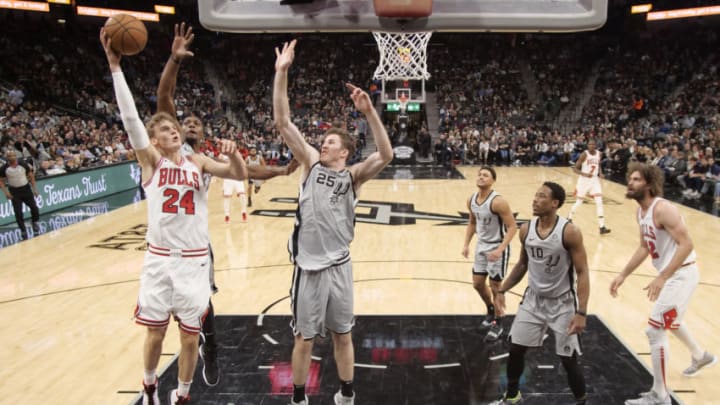 Dec 15, 2018; San Antonio, TX, USA; Chicago Bulls power forward Lauri Markkanen (24) shoots the ball over San Antonio Spurs small forward Dante Cunningham (behind) and Jakob Poeltl (25) during the first half at AT&T Center. (Soobum Im-USA TODAY Sports)