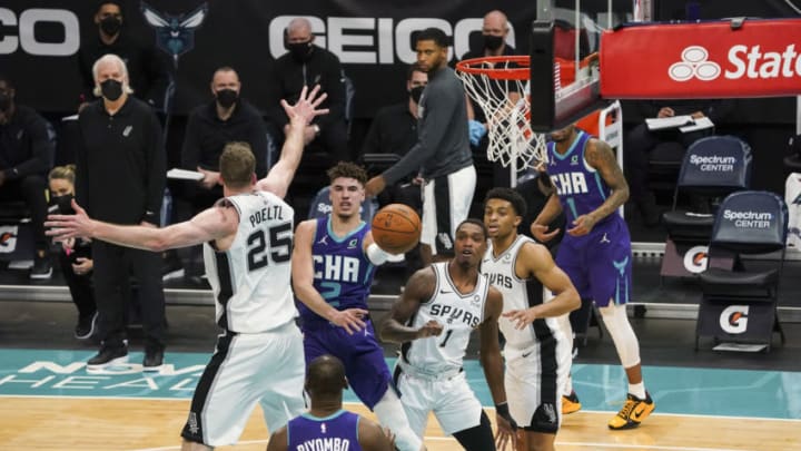 Feb 14, 2021; Charlotte, North Carolina, USA; Charlotte Hornets guard LaMelo Ball (2) passes off to center Bismack Biyombo (8) against the San Antonio Spurs during the first quarter at Spectrum Center. Mandatory Credit: Jim Dedmon-USA TODAY Sports