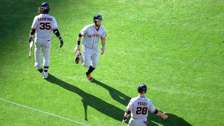 June 20, 2015; Los Angeles, CA, USA; San Francisco Giants first baseman Brandon Belt (9) is congratulated by shortstop Brandon Crawford (35) and catcher Buster Posey (28) after hitting a two run home run in the sixth inning against the Los Angeles Dodgers at Dodger Stadium. Mandatory Credit: Gary A. Vasquez-USA TODAY Sports