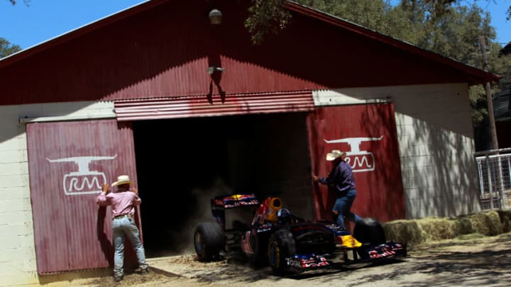 JOHNSON CITY, TX - AUGUST 19: Former Formula One driver David Coulthard of Great Britain drives the Red Bull Show Car out of a barn at a ranch on August 19, 2011 in Johnson City, Texas. (Photo by Tom Pennington/Getty Images for Red Bull)