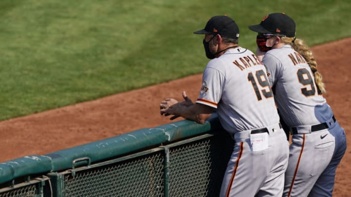 OAKLAND, CALIFORNIA - SEPTEMBER 20: Manager Gabe Kapler #19 and assistant coach Alyssa Nakken #92 of the San Francisco Giants looks on against the Oakland Athletics in the top of the six inning at RingCentral Coliseum on September 20, 2020 in Oakland, California. (Photo by Thearon W. Henderson/Getty Images)