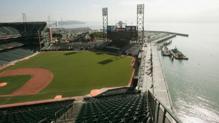 MLB - Oracle Park in San Francisco pictured from the upper deck in left  field. McCovey Cove and the San Francisco Bay are visible beyond right  field.